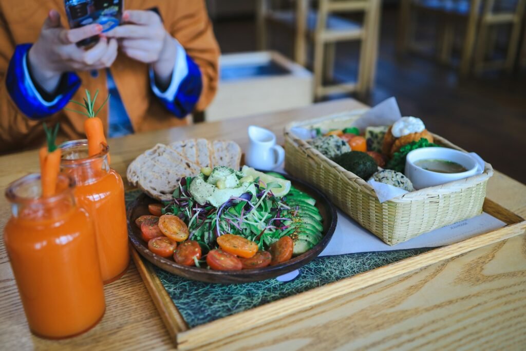 Tendencias en Brunch Miami 2025 - a person taking a picture of a plate of food